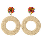 Earrings with a multicoloured beaded stud above a woven raffia hoop