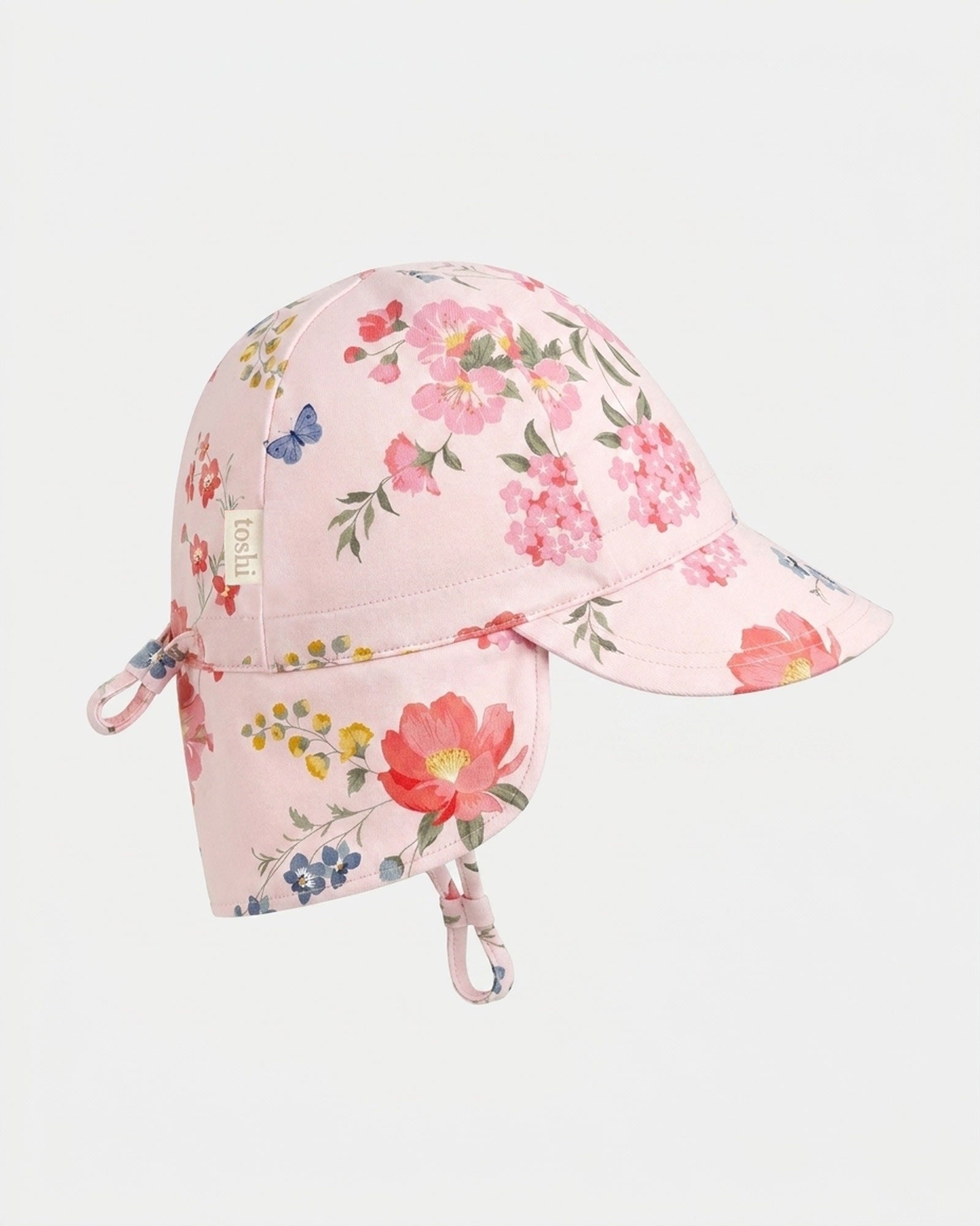 Toshi Arcadia Wild Garden flap cap in pale pink cotton with a floral and butterfly print and a neck flap