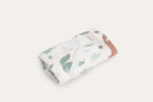 The Foxie muslin wrap rolled and tied with white cotton tape.