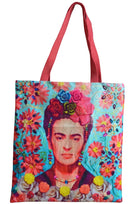 Canvas tote printed with Frida Kahlo, roses in her hair, among coral daisies on turquoise, with long coral-red woven handles