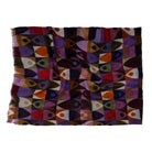 The geometric print scarf laid flat with its fringed ends