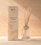 The Geranium reed diffuser, a ribbed glass bottle with natural reeds, beside its cream box.