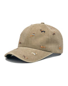 Khaki-beige brushed cotton cap embroidered with small dachshunds in coloured coats, shown from the front.