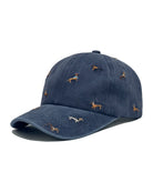 Navy brushed cotton cap embroidered with small dachshunds in coloured coats, shown from the front.