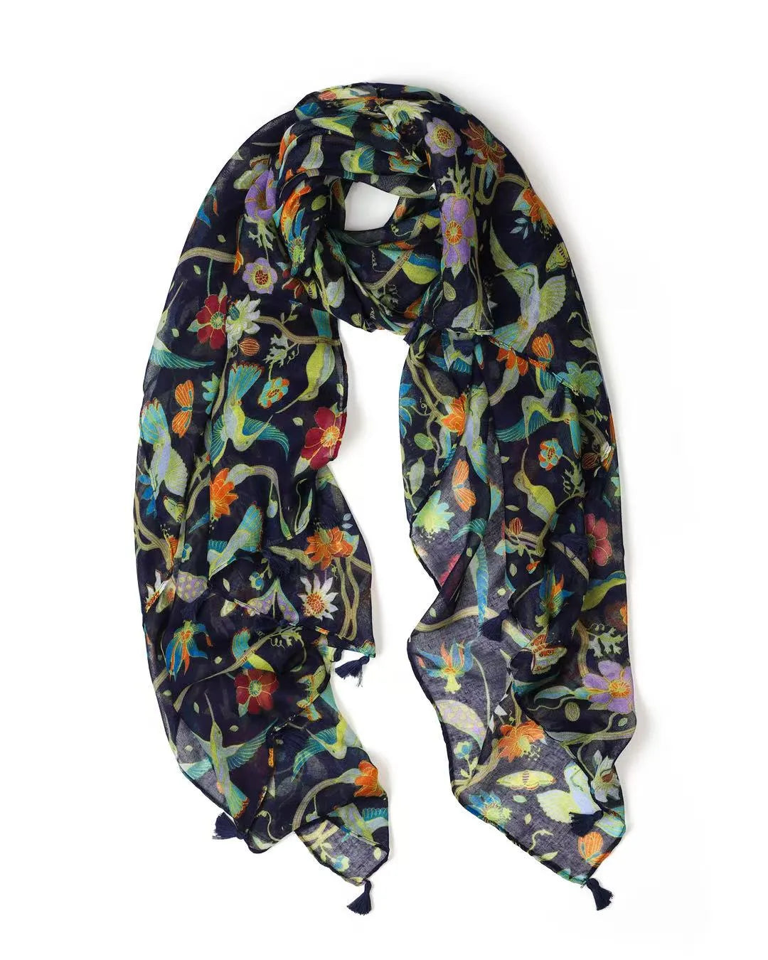 Navy lightweight scarf printed with bright botanical flowers and birds, looped to show the navy tassels at each end.