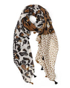 Lightweight cream scarf in a split leopard-print and polka-dot design in tan, brown and black, looped to show the tassels.