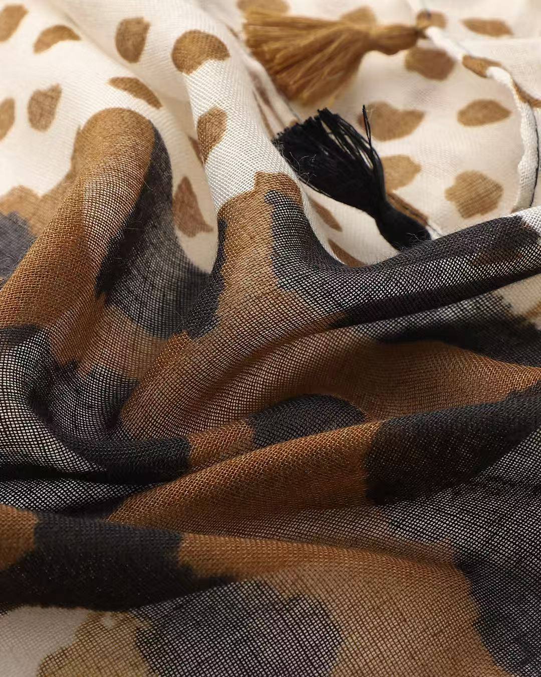 Close-up of the leopard and spot scarf fabric showing the brown animal print meeting the spotted panel.