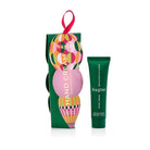Green Huxter hanging hand cream box with a circle-patterned bauble and ribbon loop, beside the green Bergamot & Cassis tube.