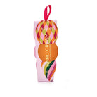 Pink Huxter hand cream box with a diamond-patterned bauble and an orange circle on the front, and a pink ribbon loop.