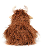 Back view of the cow, all long rust-coloured fur with its cream horns and ears showing.