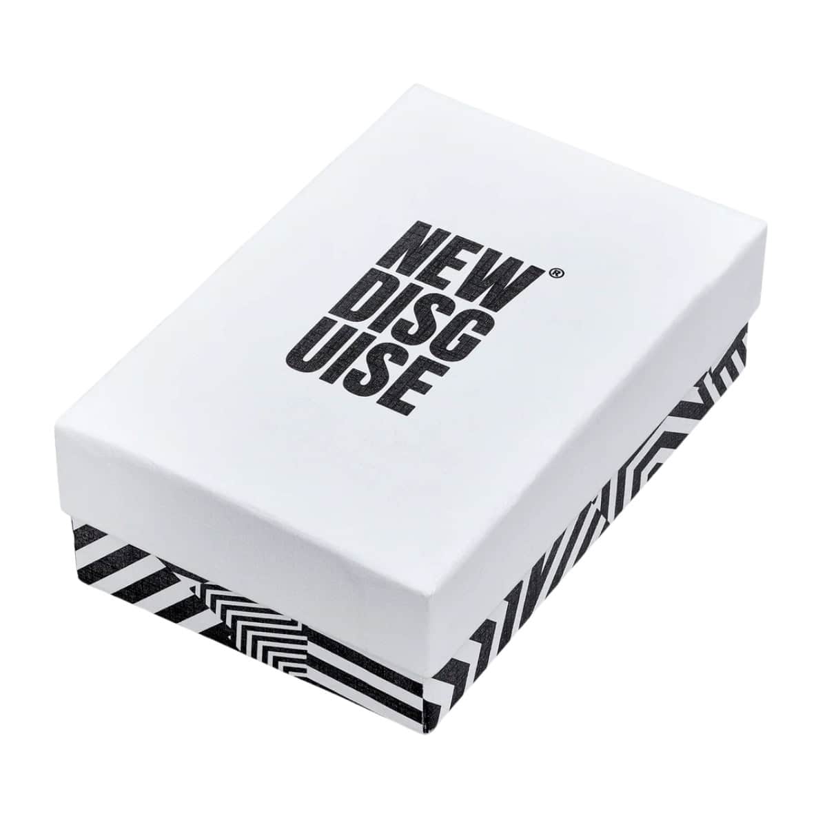 New Disguise gift box: a white lid with the brand name in black, over a black and white striped base.