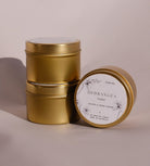 Three gold Hydrangea travel tins, one tipped forward to show its lid label with a drawing of the hydrangea.