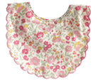 Scallop edged baby bib in pink and yellow floral print, front view