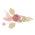 Hair clip with a light pink fabric rose, blossom, crystal and leaves on a gold setting