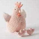 The pink Josie Chicken plush on its own, sitting with its feet out.