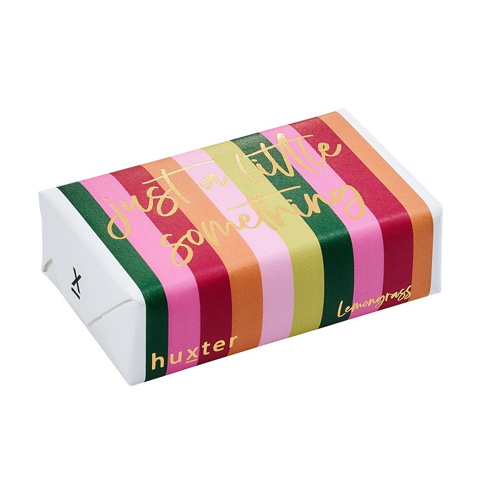 Huxter soap hand wrapped in pink, green, orange and red striped paper, with Just a little something and Lemongrass in gold foil.