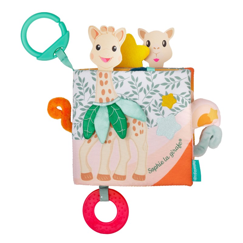 The soft activity book standing open, showing Sophie and a leaf flap, with a teal hanging ring above and a red teething ring below.