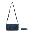 The woven bag hanging from its long adjustable strap.