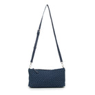The woven bag hanging from its long strap, seen from the front.