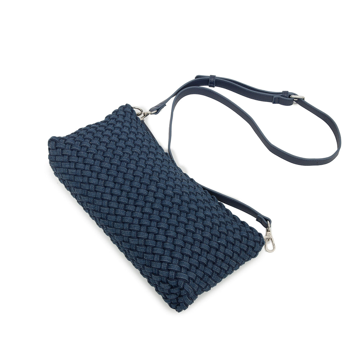 The woven bag lying flat with the long strap looped above it.