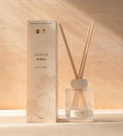 The Lotus reed diffuser, a ribbed glass bottle with natural reeds, beside its cream box.