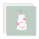 Square sage-green card with a three-tier white wedding cake, pink flowers and a heart on top, lettered love, laughter & happily ever after, on a white envelope