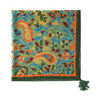 Corner detail of the paisley print with a green tassel