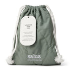 Quilted sage-green Salus drawstring bag with white cord ties and a tag reading Luminous Skin Trio.