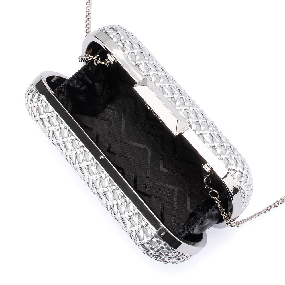 The clutch open, showing a black zigzag-patterned lining and the chain clipped inside