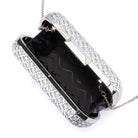 The clutch open, showing a black zigzag-patterned lining and the chain clipped inside