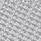 Close-up of metallic silver strips woven in an open lattice over grey