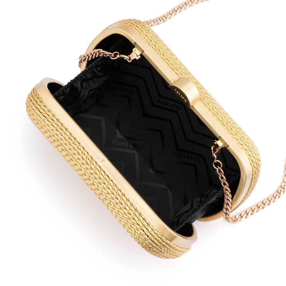 The clutch open, showing a black zigzag-patterned lining and the chain clipped inside