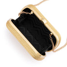 The clutch open, showing a black zigzag-patterned lining and the chain clipped inside