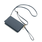 The slate blue wallet at an angle with the long strap and wrist strap attached.