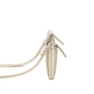 Side view of the gold clutch, showing its slim depth and strap clips.