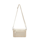 The gold clutch hanging from its long adjustable strap.