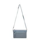 The blue clutch hanging from its long adjustable strap.