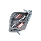 The open clutch holding a phone and two small pink compacts.