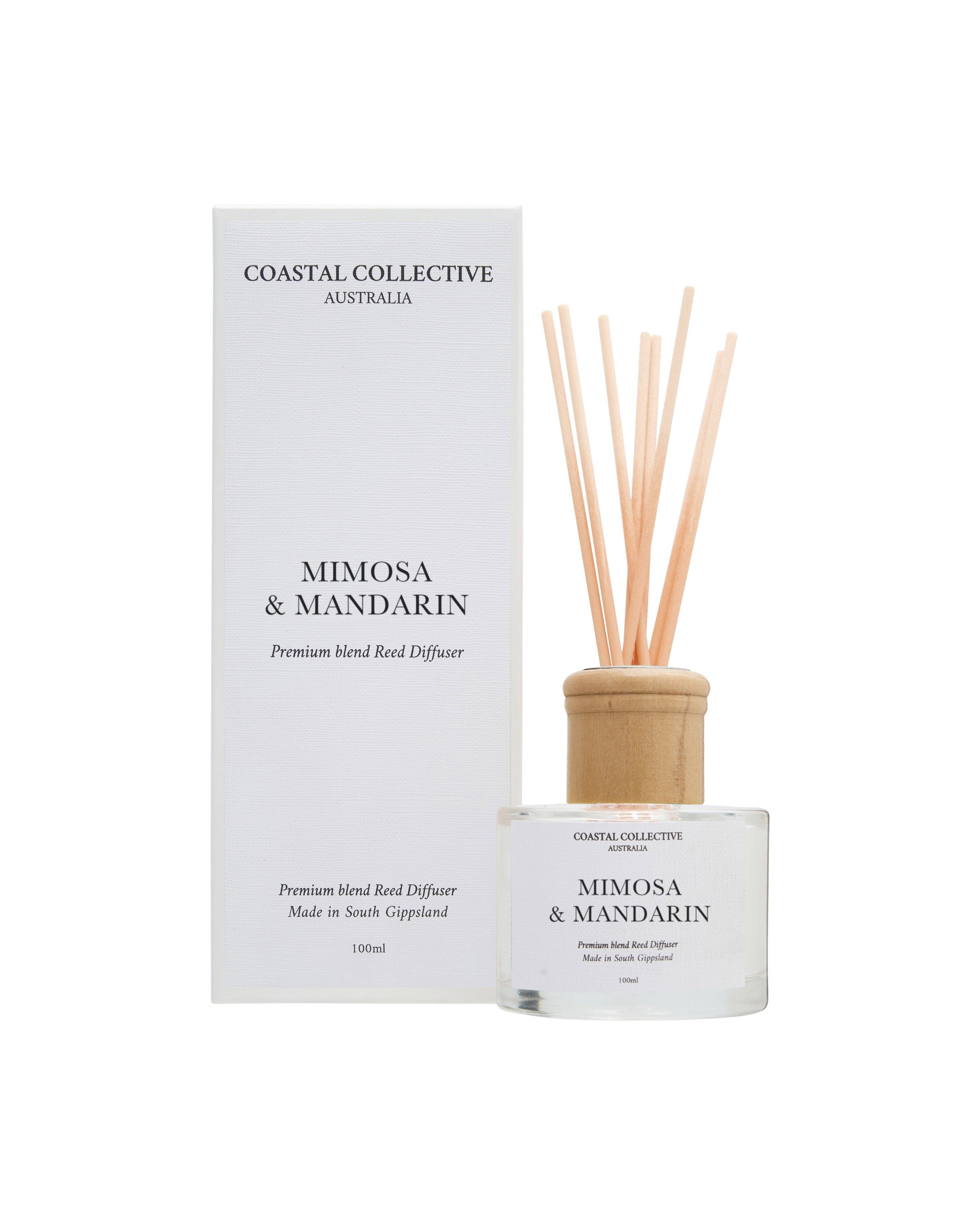 Mimosa & Mandarin reed diffuser, bottle and reeds in front of the matching box.