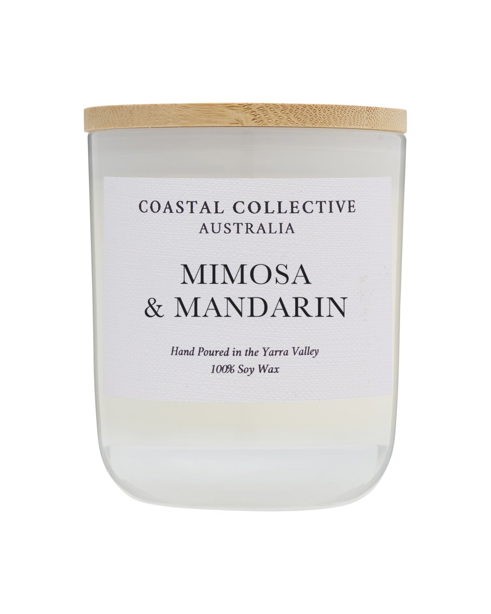 Mimosa & Mandarin candle in a taller frosted jar with a pale wooden lid.