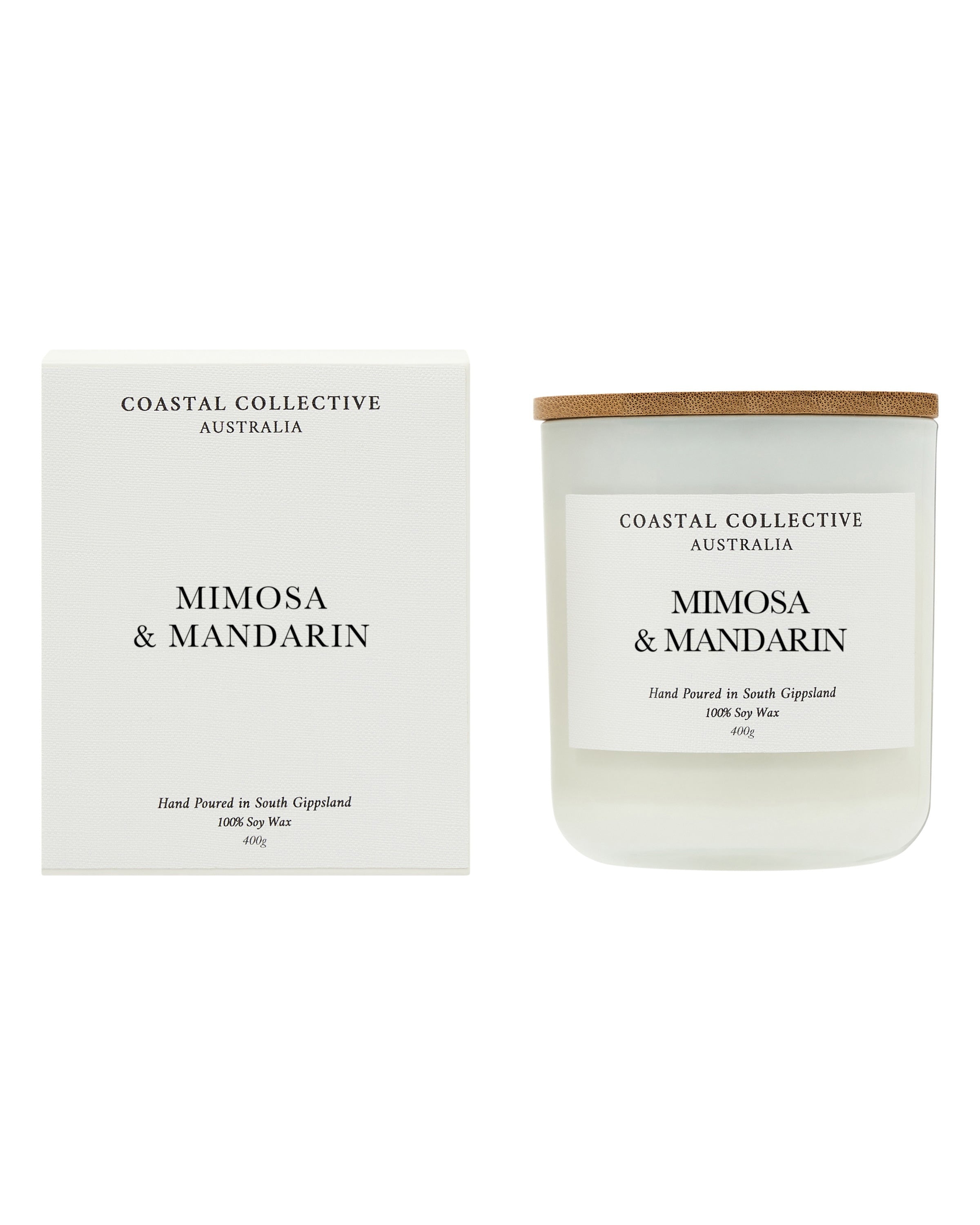 The Mimosa & Mandarin candle standing beside its printed white gift box.