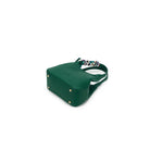 The green bag from below, showing four gold-tone feet on its base.