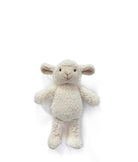 The sheep rattle lying flat with its arms out, showing its curly cream fur.