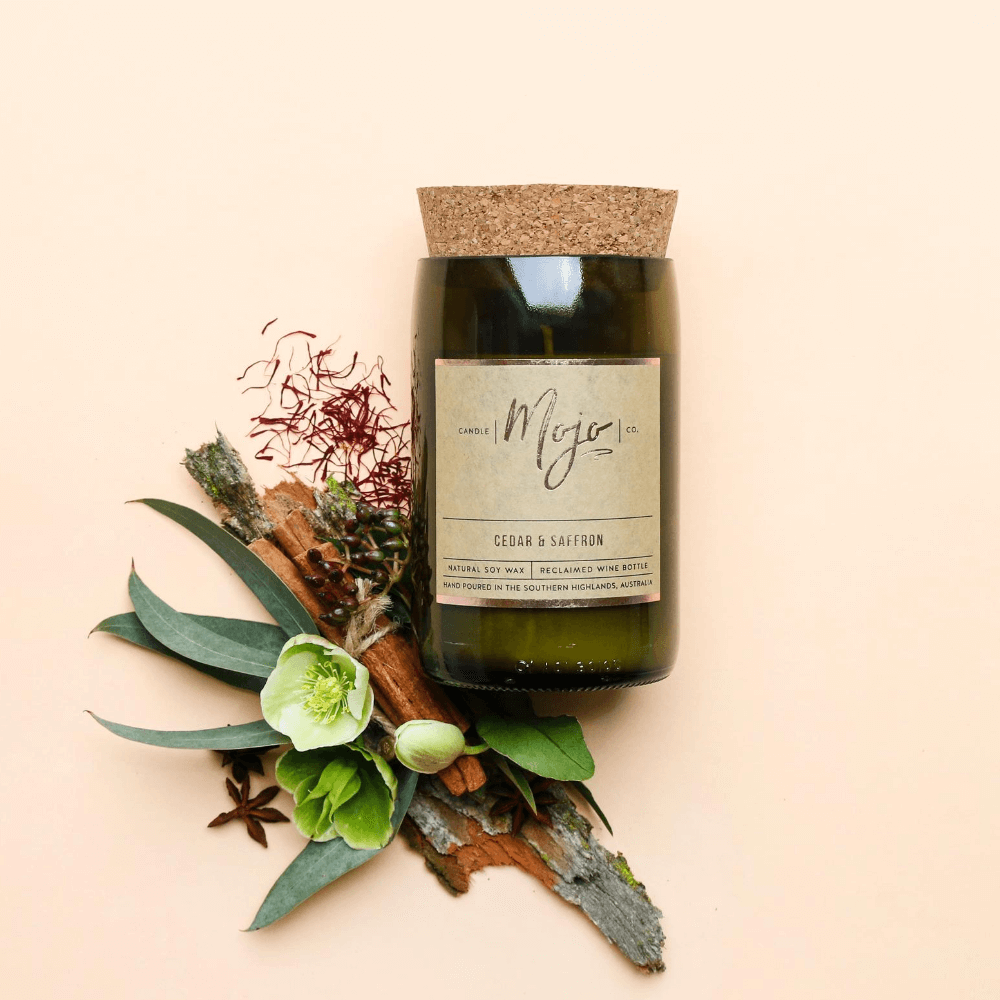 Cedar & Saffron candle on apricot with eucalyptus, driftwood, red berries and star anise