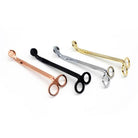 Wick trimmers fanned out in rose gold, black, gold and silver