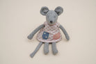Grey mouse in a pink diamond-print dress with a blue star pocket and a pink pocket.