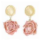Drop earrings with a textured gold-tone disc and a light pink dried rose bud
