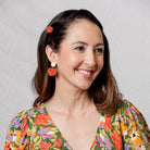 Marples earrings in orange worn with a floral dress