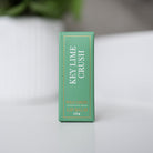 Slim green box of Key Lime Crush lip balm standing on a white surface.