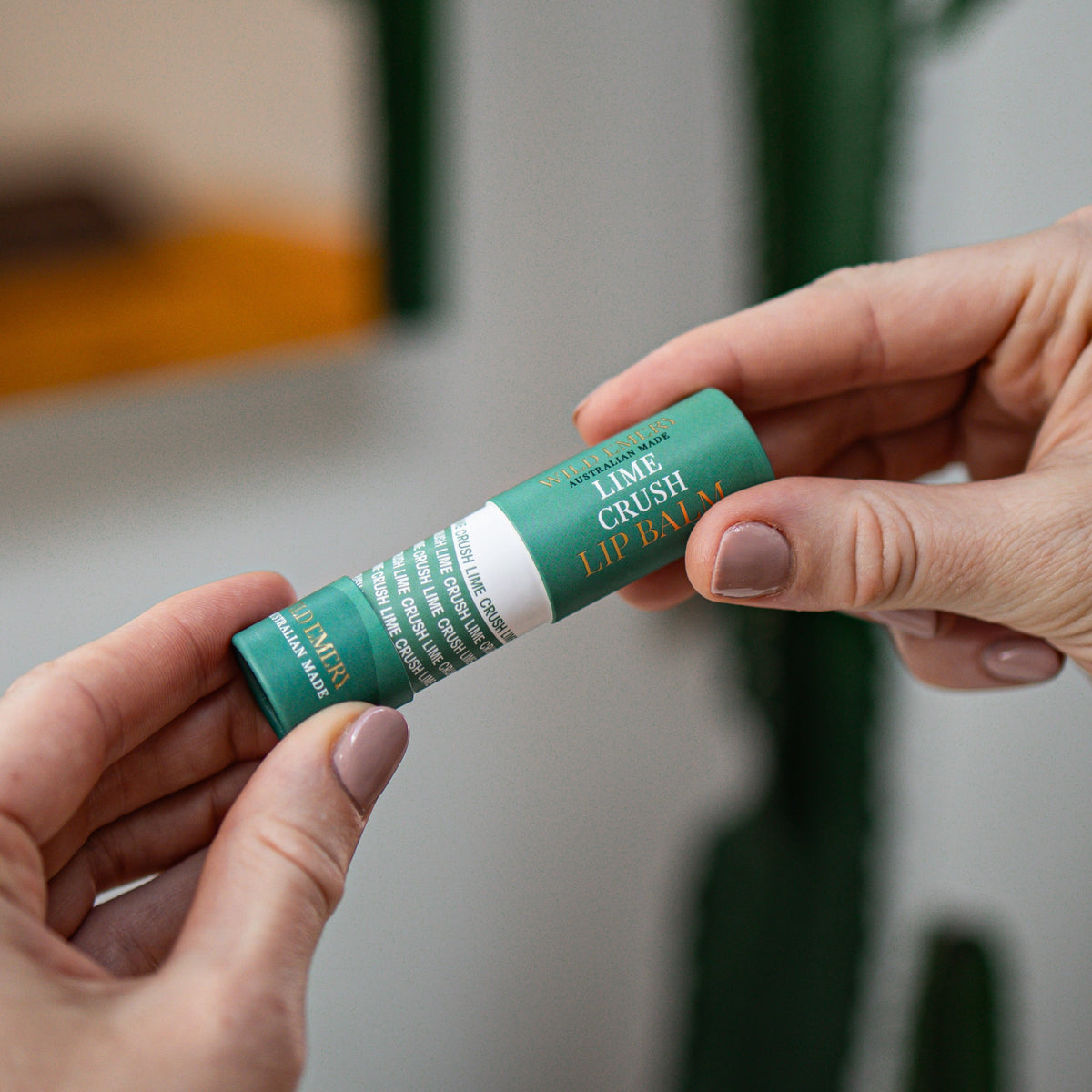 Hands pulling the Key Lime Crush tube apart, showing the inner sleeve printed with its name.